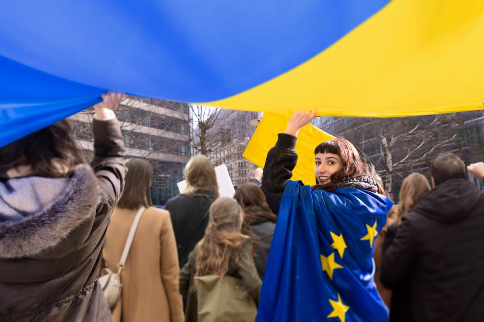Woman smiling and holding European flag